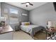 Cozy bedroom with a ceiling fan, a comfortable bed, and a dresser at 13365 Chesapeake Pl, Spring Hill, FL 34609
