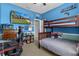 Bright bedroom with a bunk bed, gaming station, and blue accent wall at 13365 Chesapeake Pl, Spring Hill, FL 34609