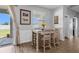 The well-lit dining area features access to the backyard and a stylish table with seating for four at 13365 Chesapeake Pl, Spring Hill, FL 34609