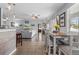 Open-concept kitchen and dining area leading into a spacious living room with lots of natural light at 13365 Chesapeake Pl, Spring Hill, FL 34609
