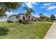 Well-maintained single-story home with beautiful landscaping, a lush green lawn and a side entry garage at 13365 Chesapeake Pl, Spring Hill, FL 34609