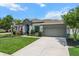 Charming home with a two-car garage, well-maintained lawn, and lush landscaping at 13365 Chesapeake Pl, Spring Hill, FL 34609