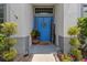 Welcoming blue front door with decorative wreath, pot, and 'Welcome' sign at 13365 Chesapeake Pl, Spring Hill, FL 34609