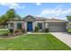 Well-maintained front exterior with manicured lawn and inviting blue front door at 13365 Chesapeake Pl, Spring Hill, FL 34609