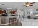 Open concept living space with kitchen island and barstool seating flows into a spacious living area at 13365 Chesapeake Pl, Spring Hill, FL 34609