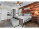 Serene main bedroom featuring a wood accent wall, plush bed, and stylish decor at 13365 Chesapeake Pl, Spring Hill, FL 34609