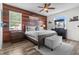 Inviting main bedroom with wood accent wall, plush bedding, and ample natural light at 13365 Chesapeake Pl, Spring Hill, FL 34609