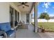 Covered patio featuring a ceiling fan, comfortable seating, and view of the fenced-in backyard at 13365 Chesapeake Pl, Spring Hill, FL 34609