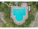 Aerial view showcases a unique community pool design with lane lines, surrounded by brick and lounge chairs at 13365 Chesapeake Pl, Spring Hill, FL 34609