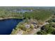 Breathtaking aerial view of a lakeside home surrounded by tall pines and lush greenery offers ultimate privacy at 18101 Boy Scout Rd, Odessa, FL 33556