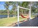 A hammock on the back deck makes the backyard the perfect place to unwind and relax by the lake at 18101 Boy Scout Rd, Odessa, FL 33556