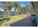 Lovely view of the backyard featuring the lake, a hammock, and a view of the home at 18101 Boy Scout Rd, Odessa, FL 33556