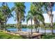 Relax on the deck in this lush backyard overlooking a tranquil lake, creating an ideal spot for outdoor enjoyment at 18101 Boy Scout Rd, Odessa, FL 33556