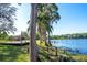 Expansive backyard with mature trees leading to a picturesque lakefront at 18101 Boy Scout Rd, Odessa, FL 33556