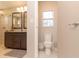 Connected bathroom with a shower and toilet on the other side at 18101 Boy Scout Rd, Odessa, FL 33556