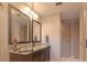 Sleek bathroom features granite countertops, dual mirrors, and modern fixtures, providing a functional space at 18101 Boy Scout Rd, Odessa, FL 33556