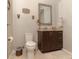 Bathroom with granite-topped vanity, decorative sconces, and a mosaic-framed mirror at 18101 Boy Scout Rd, Odessa, FL 33556