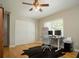 Bedroom features wood floors, double door closet, and dual monitor desk, with backyard views through the window at 18101 Boy Scout Rd, Odessa, FL 33556