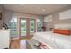 Bright bedroom boasts hardwood floors, neutral walls, and tranquil outdoor views from the glass doors at 18101 Boy Scout Rd, Odessa, FL 33556