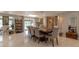 Dining room with neutral walls and tile floors is decorated with unique decorative art at 18101 Boy Scout Rd, Odessa, FL 33556