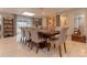 Dining room features a long wood table, eight chairs, neutral decor and access to the porch at 18101 Boy Scout Rd, Odessa, FL 33556