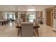 Bright and airy dining room featuring a large wooden table, tile floors and neutral paint at 18101 Boy Scout Rd, Odessa, FL 33556