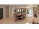 Open-concept dining room featuring a large table, tile floors and view of the screened in porch at 18101 Boy Scout Rd, Odessa, FL 33556