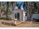 Quaint outbuilding complemented by an inviting wooden deck and verdant landscaping creates a serene outdoor space at 18101 Boy Scout Rd, Odessa, FL 33556