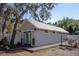 Eye-catching outbuilding with a unique roof design and complementary trim is surrounded by lush greenery and landscaping at 18101 Boy Scout Rd, Odessa, FL 33556