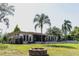 Lakeside house exterior with a fire pit and a backyard overlooking serene waters at 18101 Boy Scout Rd, Odessa, FL 33556