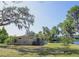 Well-maintained backyard features a serene lake view and a lovely outbuilding that seamlessly blends with the natural setting at 18101 Boy Scout Rd, Odessa, FL 33556
