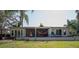 Home exterior featuring a screened-in porch with views of the serene backyard at 18101 Boy Scout Rd, Odessa, FL 33556