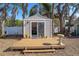 Charming backyard outbuilding, complete with a wooden deck and serene landscape, offering a peaceful retreat at 18101 Boy Scout Rd, Odessa, FL 33556