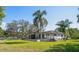 Exterior view of the home with a spacious backyard, mature trees, and plenty of room for outdoor activities at 18101 Boy Scout Rd, Odessa, FL 33556
