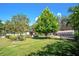 Lush lawn and landscaping accentuate this lovely home, complete with an adjacent outbuilding and gated entrance at 18101 Boy Scout Rd, Odessa, FL 33556