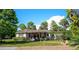Attractive single-story home with a covered front porch, well-manicured lawn, and lush landscaping providing great curb appeal at 18101 Boy Scout Rd, Odessa, FL 33556