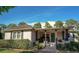 Inviting home with a cozy covered porch, accented by classic rocking chairs and stone pillars, offering a warm welcome at 18101 Boy Scout Rd, Odessa, FL 33556