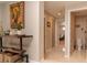 Hallway view with a console table, decorative items, and a doorway leading to the bathroom at 18101 Boy Scout Rd, Odessa, FL 33556