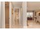 Hallway featuring neutral walls, a glimpse of a bathroom, and an open doorway to the living area at 18101 Boy Scout Rd, Odessa, FL 33556