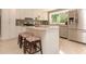 Close up view of kitchen with granite counters, white cabinets and stainless steel appliances at 18101 Boy Scout Rd, Odessa, FL 33556