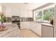 Spacious kitchen with white cabinets, stainless steel appliances and granite countertops, perfect for culinary enthusiasts at 18101 Boy Scout Rd, Odessa, FL 33556