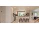 Open kitchen with white cabinets, stainless appliances, a breakfast bar and tiled floors at 18101 Boy Scout Rd, Odessa, FL 33556