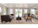 Inviting living room featuring a cozy couch, decorative rug, and a serene view of the outside pond at 18101 Boy Scout Rd, Odessa, FL 33556