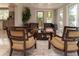 Elegant living room with hardwood floors, comfortable seating, and direct access to the kitchen and outdoor view at 18101 Boy Scout Rd, Odessa, FL 33556