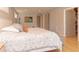 Tranquil main bedroom featuring hardwood floors, soft bedding, and a view of the ensuite bathroom at 18101 Boy Scout Rd, Odessa, FL 33556
