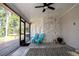 Lovely screened patio featuring tiled accent wall, two blue Adirondack chairs, and view of the lake at 18101 Boy Scout Rd, Odessa, FL 33556