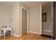 Room features wood floors, a closet, lamp with a white table and decorative objects, and a door leading to another room at 18101 Boy Scout Rd, Odessa, FL 33556