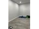 Finished basement with gray floors and exercise equipment, perfect for a home gym or recreational space at 2518 Sunset Ln, Lutz, FL 33559