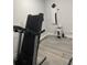 Basement area featuring a treadmill and wall-mounted equipment at 2518 Sunset Ln, Lutz, FL 33559
