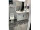 This bathroom features a sleek vanity, modern fixtures and neutral finishes at 2518 Sunset Ln, Lutz, FL 33559